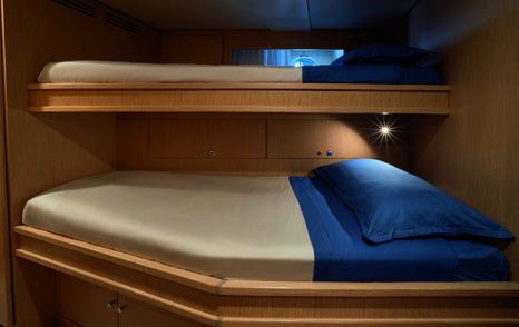 Custom Line Navetta 38 crew cabin with bunk beds, storage and compact layout on lower deck