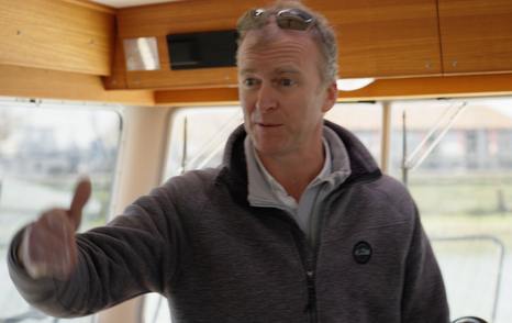 Hugo Andreae presenting the Botnia Targa 32's practical teak-lined wheelhouse during YachtBuyer's £300,000 used boat challenge.