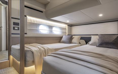 Twin cabin onboard Absolute 50Fly, two single berths with porthole windows to port side