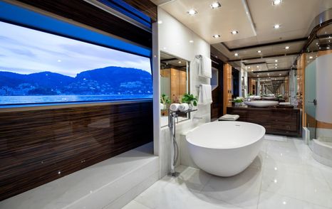 Spacious en suite bathroom with oversized bathtub and sea views