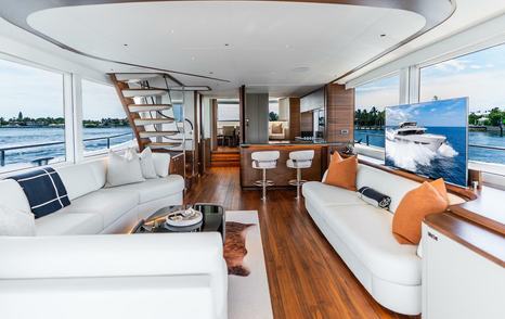 Motor Yacht Cosa Bella main saloon with bar area and curved white sofa