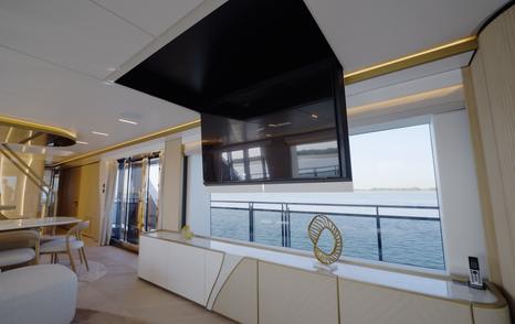 Drop down tv in the main saloon aboard the Gulf Craft Majesty 100 Terrace