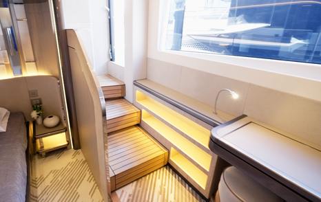 Illuminated staircase inside the Galeon 620 Fly connecting the owner’s cabin to the sea terrace.
