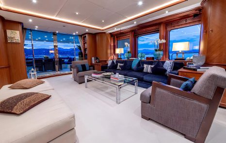 Superyacht Sea BlueZ main saloon with blue seating and glass coffee table 