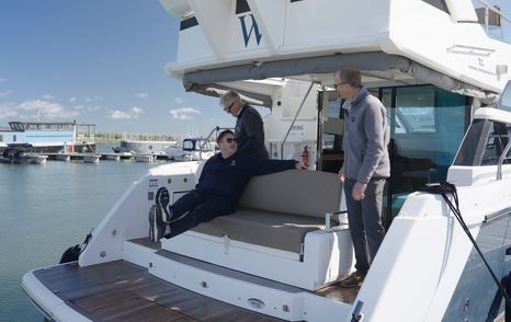Reversible aft cockpit bench seat on the Fairline Squadron 42, nicknamed the smug chair, with the presenters aboard at Essex Marina.