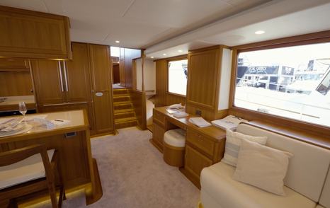 Fleming 85 saloon showing custom office area, storage cabinetry and companionway access