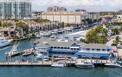 Entrance to Lauderdale Marina – Fort Lauderdale, multiple motor yachts moored, with Fort Lauderdale infrastructure in background