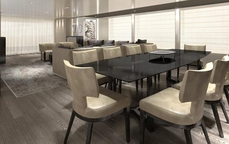 dark wooden dinning table surrounding by cream chairs and cream sofas in background in the main salon of 43M Fast superyacht