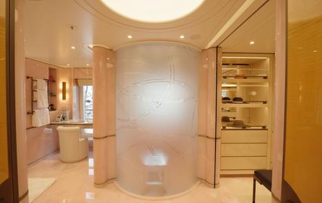 Owner’s suite bathroom on the Amels 242 Casino Royale featuring pink marble finishes and dressing areas.