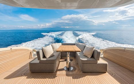 Invictus ST550 motor yacht aft deck dining set up 