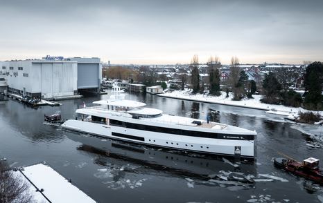 Superyacht Graycliffs in front of tugboat outside Feadship superyacht in winter 