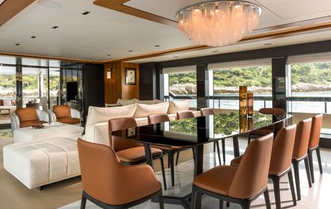 Riva 54Metri Superyacht Sairu main saloon dining area with brown leather seating 