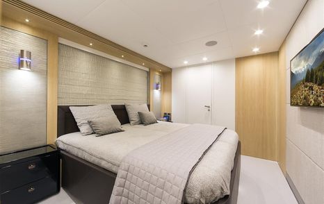 Cabin onboard the superyacht O NOSO UNO, central berth facing starboard, directly opposite a wall-mounted TV