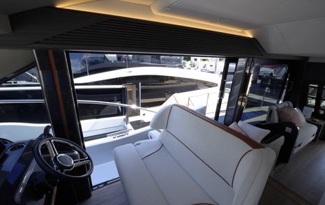 Galeon 520 Fly helm seating area with side deck access door and forward visibility from the wheel