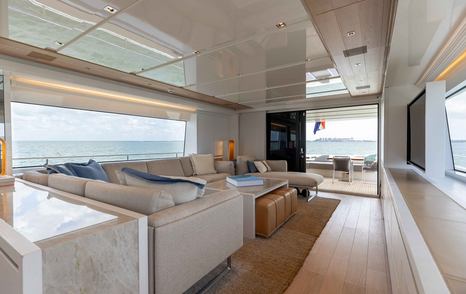 Motor Yacht Sasa main saloon seating area with glass sliding doors