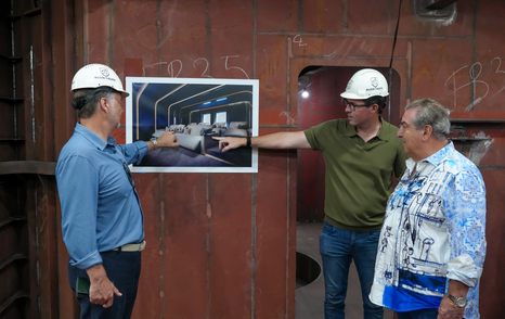 Workers showing John Staluppi rendering of Project Bond cinema room 