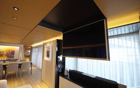 Custom Line Navetta 38 saloon with drop-down TV, integrated storage and warm timber ceiling detail