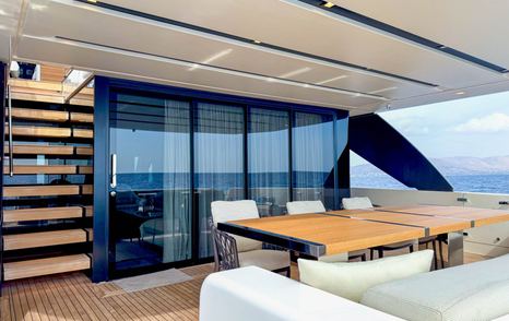 Aft deck dining table beside glass doors on SL90A/832