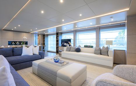 Superyacht Cofina's main saloon L-shaped seating and dining area