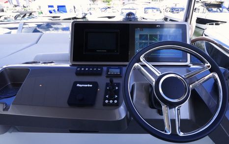 Galeon 520 Fly flybridge helm controls with throttle, joystick and steering wheel detail