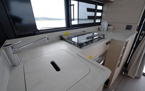 Beneteau Swift Trawler 37 Fly galley with covered sink and two-burner hob