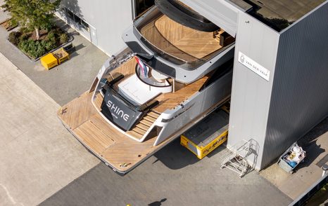 Aerial view of Superyacht Shine aft leaving shipyard 