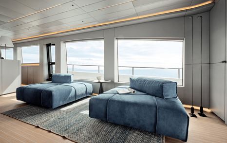 First AB Yachts AB110 hull motor yacht main saloon seating area with blue sofas
