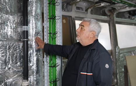 Alexei Mikhailov explaining insulation during walkthrough 