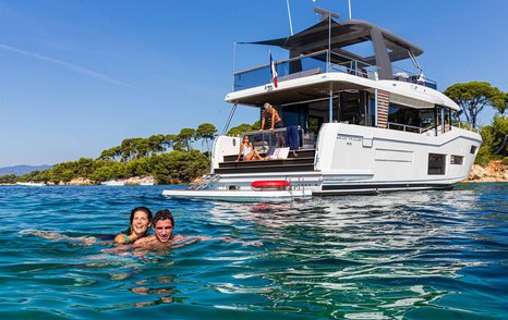 Beneteau Grand Trawler 63 at anchor with hydraulic swim platform and easy access to the water