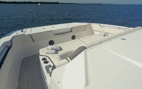 Aquila 45 Sport bow seating area with wraparound lounge and cup holders, showing open foredeck layout at anchor