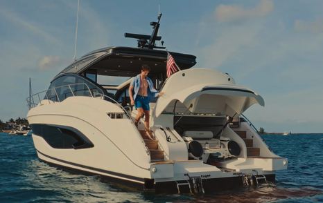 Princess V55 rear view showing hydraulic swim platform and open tender garage