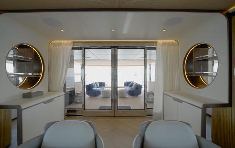 View through the Gulf Craft Majesty 145 main saloon towards the shaded aft deck lounge