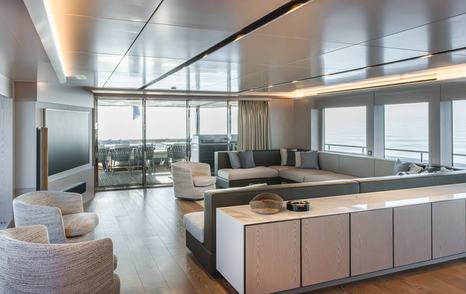 Expedition Yacht Mitan main saloon with U-shaped grey sofa 