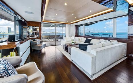 Pura Vida motor yacht main saloon with U-shaped sofa and glass sliding doors 