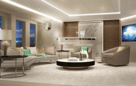 Heesen Project Aura lounge area with curved sofa and armchair around low coffee table, plus large flatscreen TV