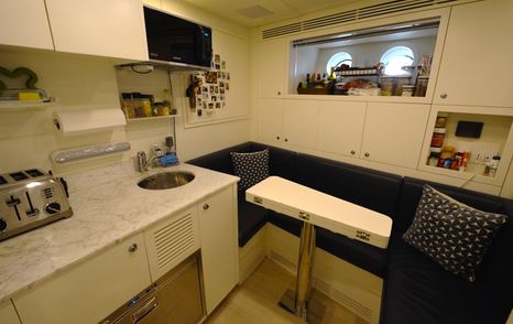 Benetti Oasis 34M crew mess with dining area, kitchenette and storage for long periods on board.