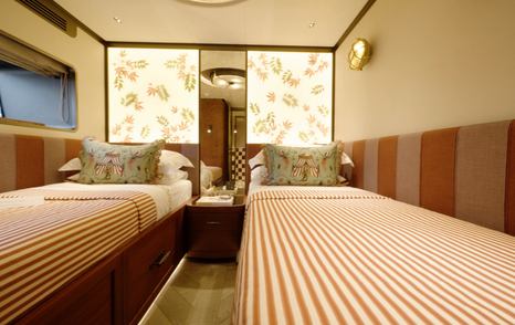 Sirena 118 red twin guest cabin with wide berths and backlit leaf panels