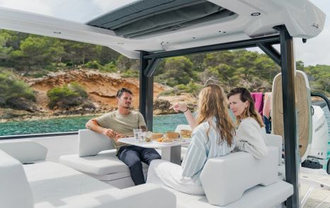 Family enjoying alfresco dining on Axopar 38 Sun Top boat 