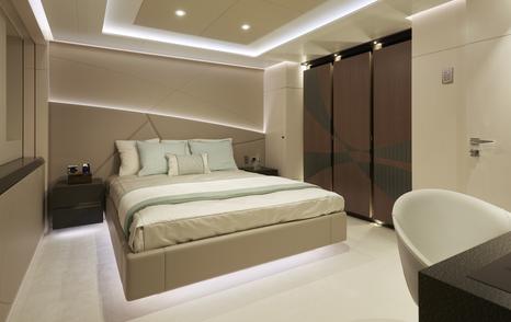 Guest cabin onboard Heesen 'Project Triton', central berth with office desk opposite