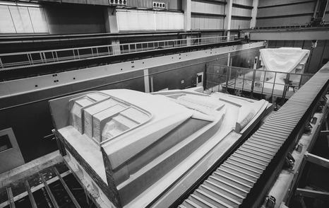 Aerial view of Ferretti 1000 in construction inside shipyard facility