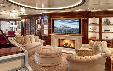 Superyacht Amadea interior with fireplace and mounted TV