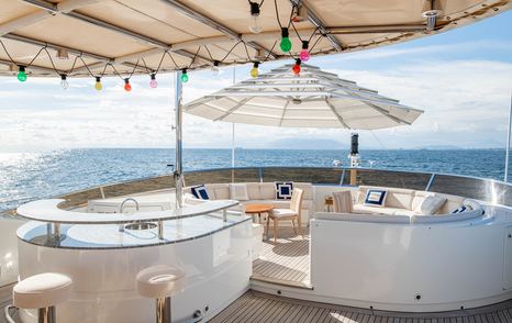 Superyacht Checkmate upper deck seating and bar area