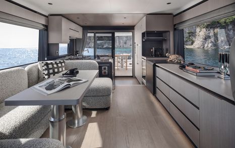 Sirena 60 motor yacht saloon with grey seating and starboard galley