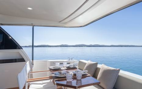 Maritimo M50 aft deck seating with dining table and open water views