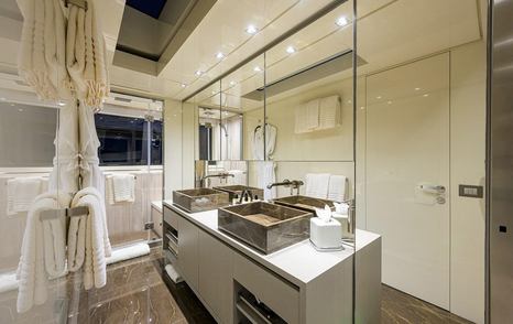 Ensuite bathroom on motor yacht Phoenix with twin sinks, a shower and marble finishings 