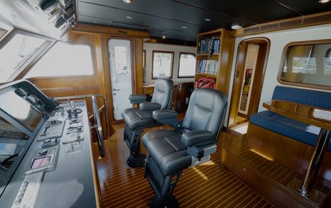 Nordhavn 75 EYF wheelhouse with twin helm seats, navigation console and raised pilothouse layout