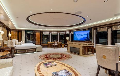 Superyacht Amadea master cabin with pop-up TV and circular rug