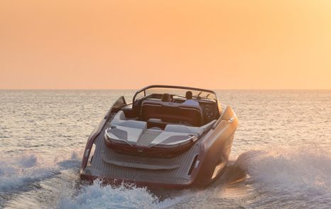 Rear view of Princess R35 underway at sunset, surrounded by sea