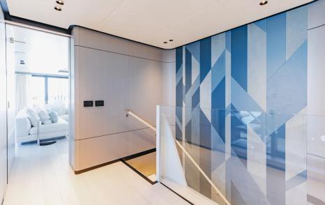 Superyacht Half Irish indoor staircase with geometric blue wallpaper 