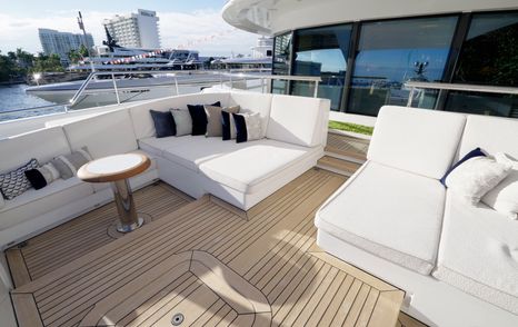 Private owner’s terrace seating area on the Amels 242 Casino Royale with outdoor sofas and teak decking.